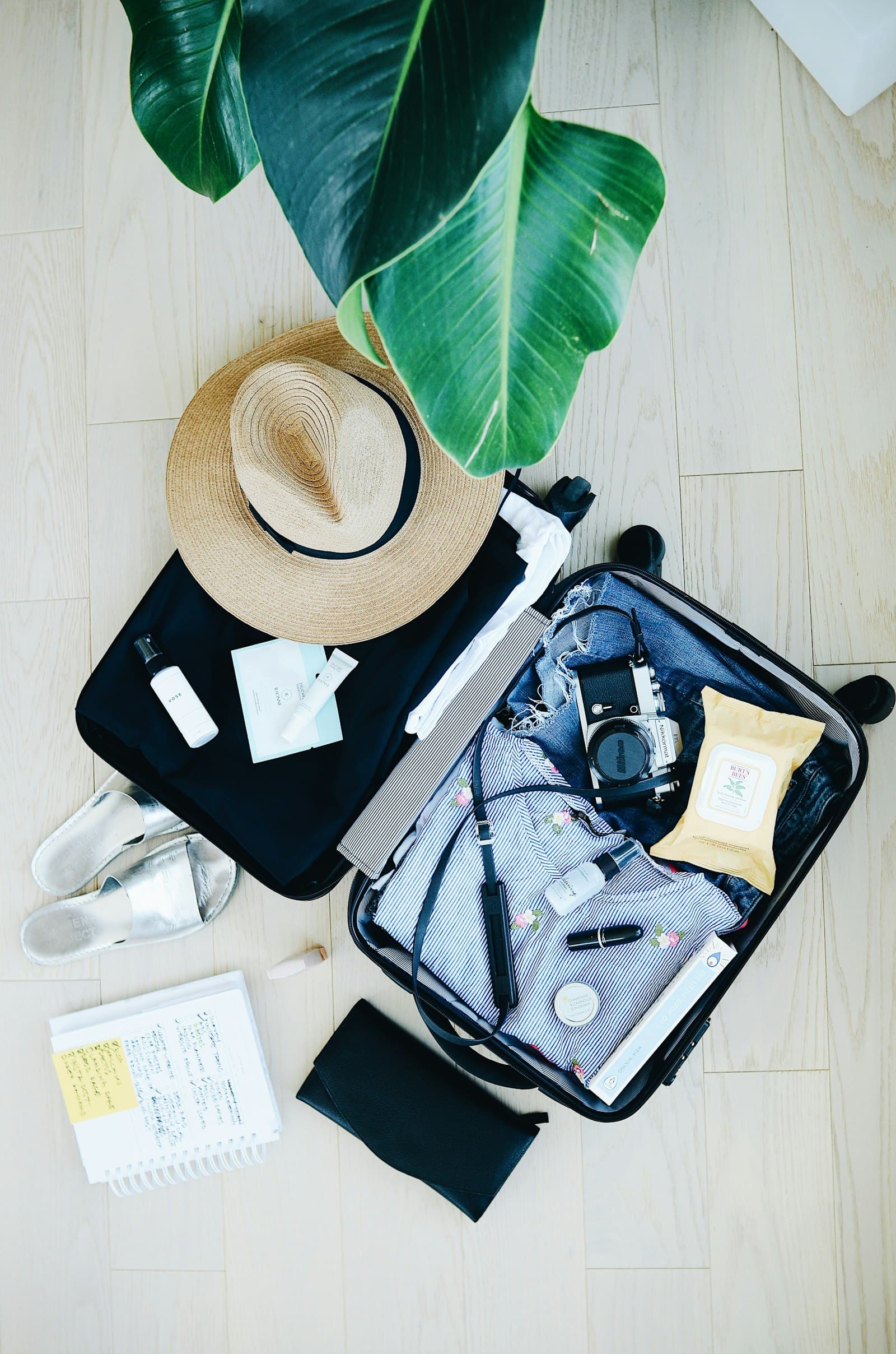 Away Bigger Carry-On: open suitcase with travel essentials and hat