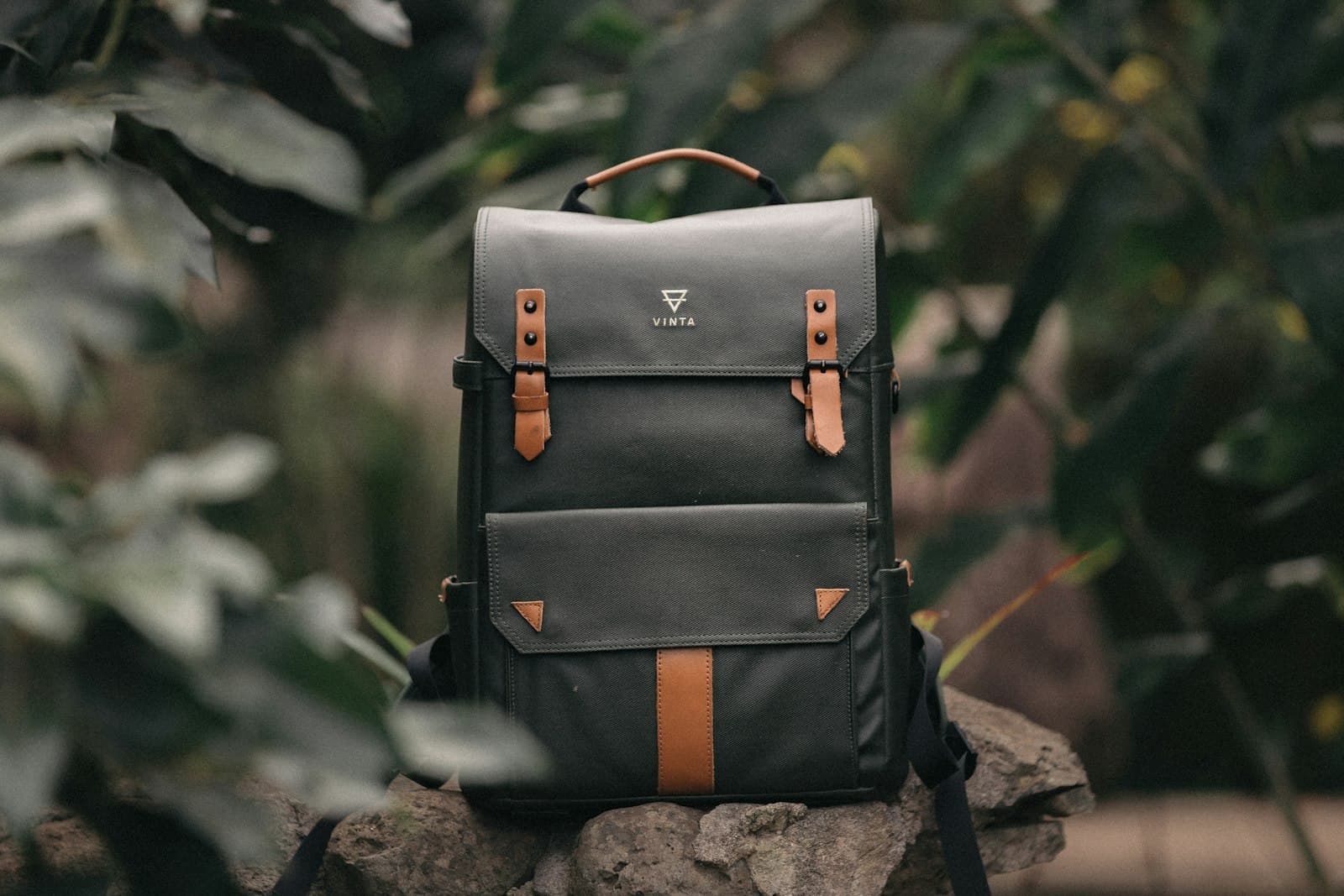 Vinta Type II camera backpack: selective focus photography of black and brown leather backpack on rock