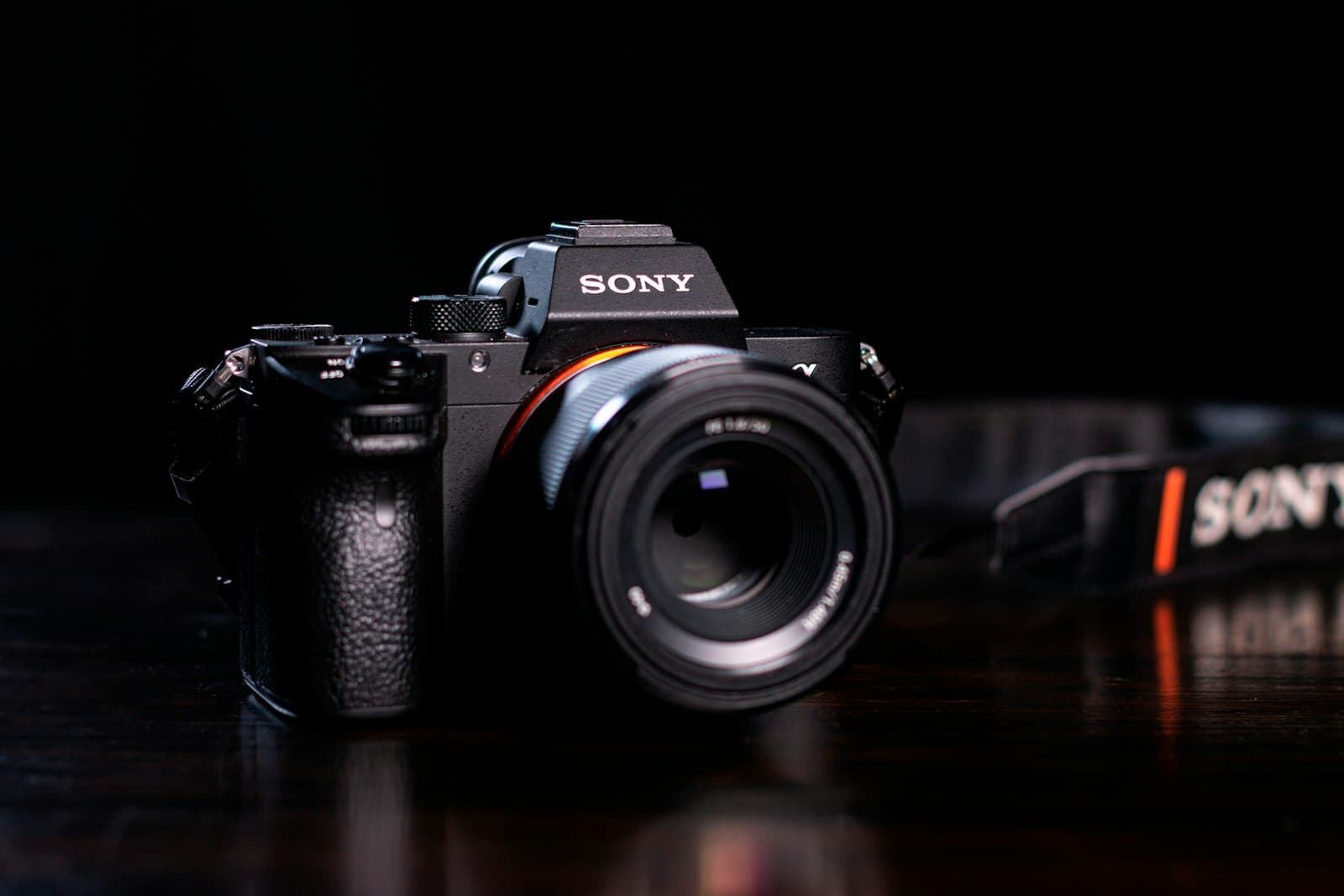 A Sony mirrorless camera on a dark table